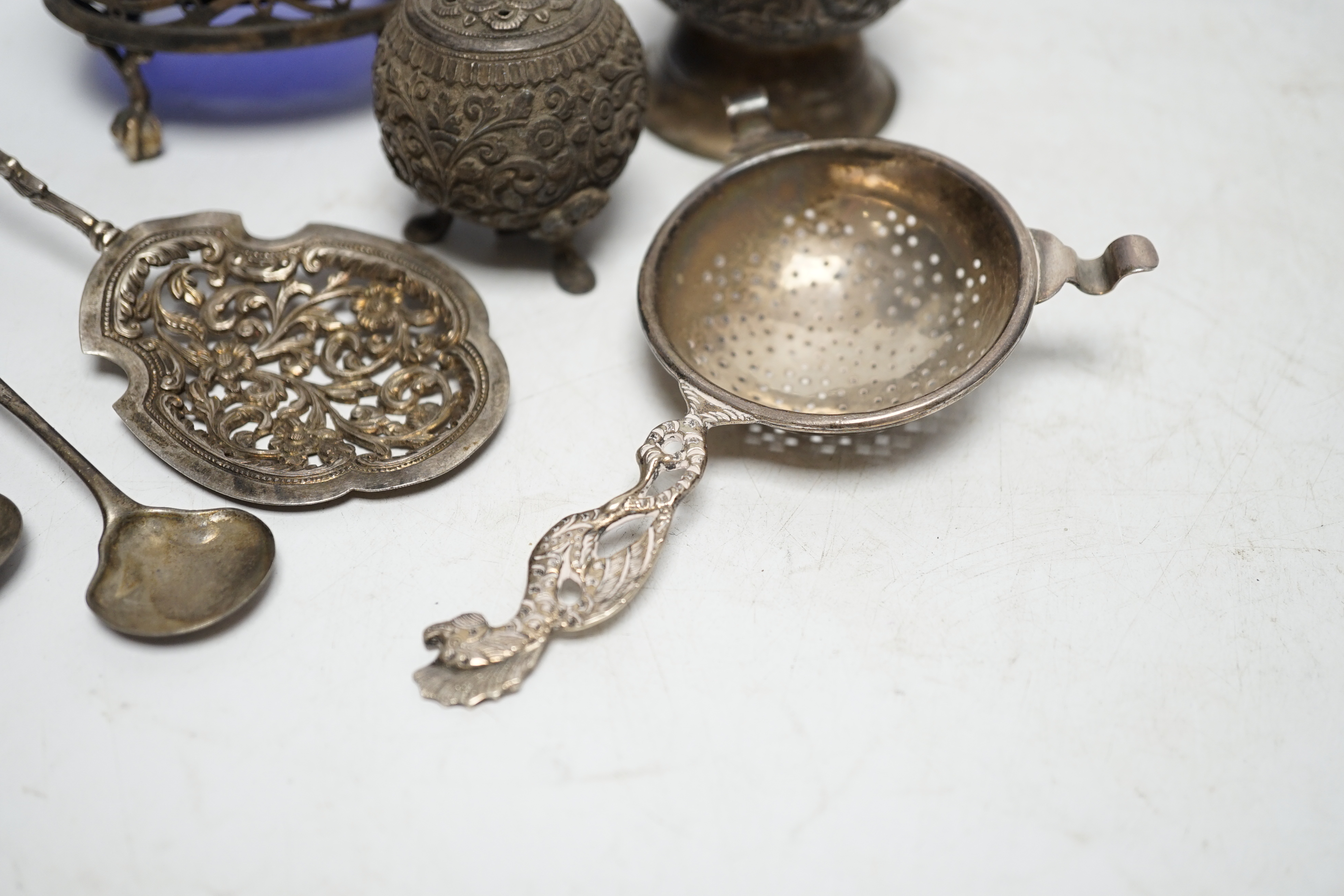 A group of small silver and white metal items including a George III oval salt, two Georgian condiment spoons, Indian condiment, etc. Condition- Fair.